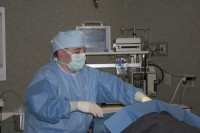 Sterile drapes are carefully placed on patient